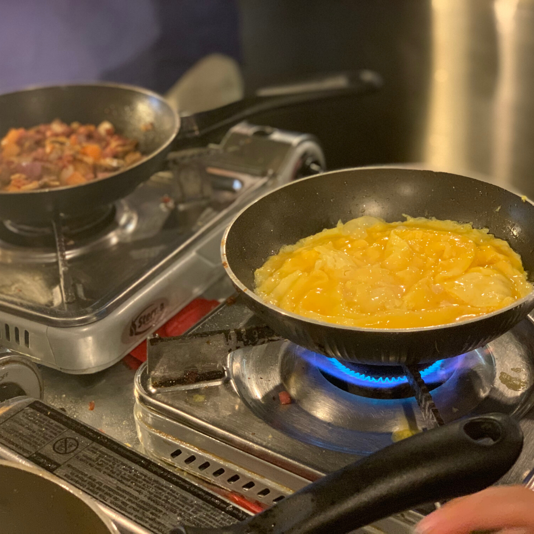 breakfast meat and cheese omelet cooking